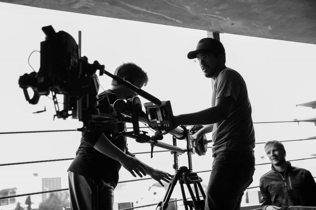 photo of a film crew setting up a camera